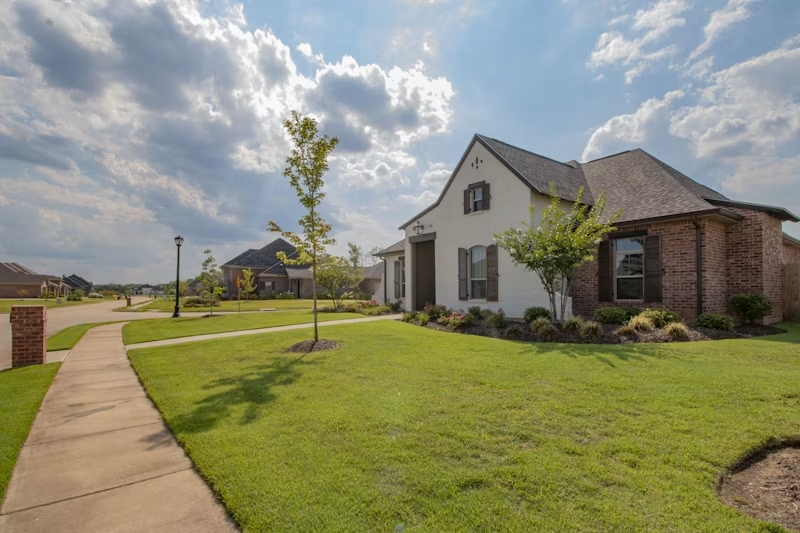 Low-maintenance artificial turf lawn bordered by pavers in Golden CO